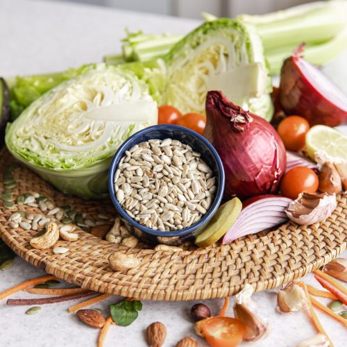 close up, a bowl of sunflower seeds and other healthy foods on the kitchen table.